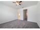 Cozy bedroom featuring neutral carpeting, ceiling fan, and two entry doors at 421 Arkansas Ct, Poinciana, FL 34759