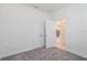 Bedroom featuring neutral carpet, a double door closet and an open doorway at 421 Arkansas Ct, Poinciana, FL 34759