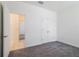 Bedroom showcasing a double door closet, neutral carpet, and a view into the hallway at 421 Arkansas Ct, Poinciana, FL 34759