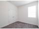 Neutral bedroom featuring double door closet, neutral carpet, and a window with blinds at 421 Arkansas Ct, Poinciana, FL 34759