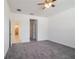 Comfortable bedroom with neutral carpet, ceiling fan, and an ensuite bathroom at 421 Arkansas Ct, Poinciana, FL 34759