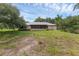 View of the back of the home with a large screened porch and grassy lawn at 18829 Starry St, Orlando, FL 32833