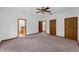 Carpeted bedroom with two doors and ceiling fan at 18829 Starry St, Orlando, FL 32833