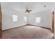 Bedroom with carpet flooring, two windows for natural light, and ceiling fan at 18829 Starry St, Orlando, FL 32833