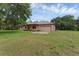 View of the front of the home showing its front porch and large, green yard at 18829 Starry St, Orlando, FL 32833