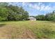 A view of the home showing the yard and the tree coverage surrounding the home at 18829 Starry St, Orlando, FL 32833