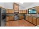 Spacious kitchen boasts wood cabinets, stainless steel appliances, and wood flooring at 18829 Starry St, Orlando, FL 32833
