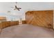 Open living room features wood paneled accent wall, carpet, and vaulted ceilings at 18829 Starry St, Orlando, FL 32833