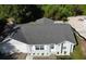 Aerial view of a gray house with a gray shingle roof and an attached two-car garage at 626 Nardello Dr, Deltona, FL 32725