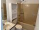 Bathroom with a combination shower and tub, vanity, and white shelving unit at 626 Nardello Dr, Deltona, FL 32725