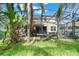 The backyard features a screened-in pool area with a patio and lush tropical landscaping at 3221 Dark Sky Dr, Harmony, FL 34773