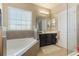 Bathroom includes a soaking tub, shower and dark wood vanity at 3221 Dark Sky Dr, Harmony, FL 34773