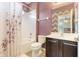 Bathroom features decorative shower curtain, toilet and dark wood vanity at 3221 Dark Sky Dr, Harmony, FL 34773