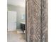 Bathroom featuring a patterned shower curtain, vanity, and neutral tiling at 3221 Dark Sky Dr, Harmony, FL 34773
