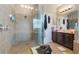 Large walk-in shower features tan tiled walls and dual shower heads at 3221 Dark Sky Dr, Harmony, FL 34773