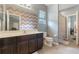 Bathroom with dark cabinets, toilet and a view to the next room at 3221 Dark Sky Dr, Harmony, FL 34773