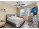 Bedroom featuring a ceiling fan, TV, dresser, and light-colored floors at 3221 Dark Sky Dr, Harmony, FL 34773
