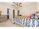 Cozy bedroom featuring a ceiling fan and ensuite bathroom for added convenience at 3221 Dark Sky Dr, Harmony, FL 34773