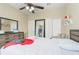 Bedroom with light walls, a ceiling fan, dresser, and access to closets at 3221 Dark Sky Dr, Harmony, FL 34773