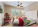 Bedroom featuring a ceiling fan, window, and furniture; shows some clutter at 3221 Dark Sky Dr, Harmony, FL 34773