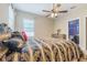 Comfortable bedroom with a ceiling fan and window, leading to a modern en-suite bathroom at 3221 Dark Sky Dr, Harmony, FL 34773