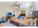 Bedroom with a ceiling fan and cluttered with various items on the bed and floor at 3221 Dark Sky Dr, Harmony, FL 34773