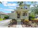 Inviting home featuring a covered front porch, two-car garage, and landscaped yard at 3221 Dark Sky Dr, Harmony, FL 34773