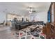 Open-concept living room featuring a ceiling fan and seamless flow into the kitchen at 3221 Dark Sky Dr, Harmony, FL 34773