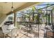 A screened patio with white wicker furniture overlooks a pool surrounded by palm trees at 3221 Dark Sky Dr, Harmony, FL 34773