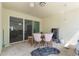 A patio with a dining set and view to the inside of the house through a sliding glass door at 3221 Dark Sky Dr, Harmony, FL 34773
