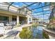 The backyard pool is surrounded by a screened lanai, patio and lush landscaping at 3221 Dark Sky Dr, Harmony, FL 34773