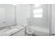 Modern bathroom with a tub shower combination, granite countertops, and contemporary fixtures at 13 Haddock Way, Poinciana, FL 34759
