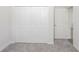 Cozy bedroom featuring plush carpeting and a spacious closet for ample storage at 13 Haddock Way, Poinciana, FL 34759