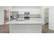 Kitchen island with stainless steel appliances and granite countertops at 13 Haddock Way, Poinciana, FL 34759