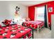 Themed bedroom featuring two beds, playful decor, and ample natural light for a fun, inviting space at 8882 Geneve Ct, Kissimmee, FL 34747