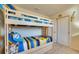Bright bedroom featuring a bunk bed with storage drawers, a fun Minion theme, and neutral carpeting at 8882 Geneve Ct, Kissimmee, FL 34747