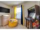 Bedroom featuring a dresser, beanbag chair, arcade game and a window with curtains at 8882 Geneve Ct, Kissimmee, FL 34747
