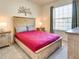 Cozy bedroom features a comfortable bed, soft lighting, and neutral decor for a relaxing retreat at 8882 Geneve Ct, Kissimmee, FL 34747