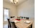 Formal dining area featuring a modern chandelier and seating for six for comfortable dining experiences at 8882 Geneve Ct, Kissimmee, FL 34747