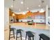 Eat-in kitchen with granite countertops, stainless steel appliances, and seating for four at the breakfast bar at 8882 Geneve Ct, Kissimmee, FL 34747
