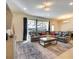 Bright living room with a large sectional sofa, stylish rug, and view of the outdoor living space at 8882 Geneve Ct, Kissimmee, FL 34747