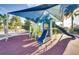 Community playground features covered seating, shade, and jungle gym at 8882 Geneve Ct, Kissimmee, FL 34747