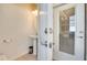 Bright powder room with a pedestal sink, neutral walls, and a glass paneled exterior door at 8882 Geneve Ct, Kissimmee, FL 34747