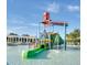 Community splash park features large dump bucket and covered slide at 8882 Geneve Ct, Kissimmee, FL 34747