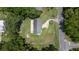 Aerial view of a home showcasing the backyard, neighboring properties, mature trees, and the street at 1143 Ne 23Rd St, Ocala, FL 34470