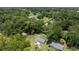 Aerial view of the property showing a home with a spacious yard surrounded by mature trees at 1143 Ne 23Rd St, Ocala, FL 34470