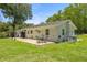 Inviting outdoor space featuring a patio with dining set and lush green lawn at 1143 Ne 23Rd St, Ocala, FL 34470