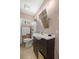 Bathroom featuring a dark brown vanity cabinet, toilet, shower and window at 1143 Ne 23Rd St, Ocala, FL 34470