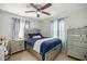 Cozy bedroom featuring a large bed with silver trim and matching nightstand and dresser set at 1143 Ne 23Rd St, Ocala, FL 34470