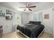 Cozy bedroom with ceiling fan, simple decor, and large window at 1143 Ne 23Rd St, Ocala, FL 34470